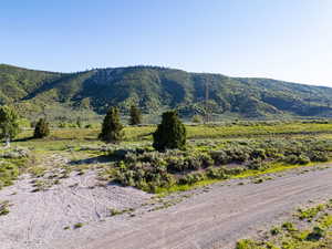 View of mountain backdrop featuring rural landscape