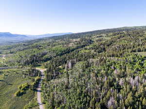 View of property location with a forest and a mountain backdrop