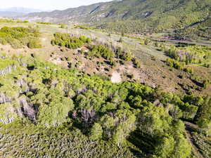 Aerial view of property and surrounding area featuring mountains