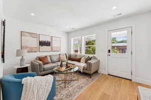 Living room featuring light wood-style floors and recessed lighting