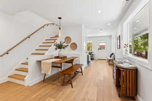 Corridor featuring stairway, recessed lighting, and light wood-style flooring