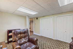 Living area with carpet flooring and baseboards