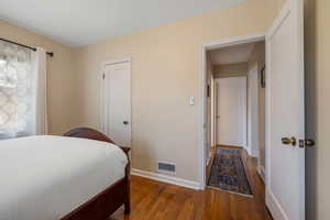 Bedroom featuring baseboards and wood finished floors