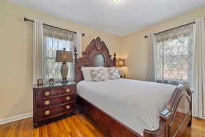 Bedroom featuring wood finished floors and baseboards