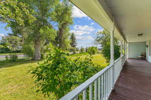 Porch featuring a lawn
