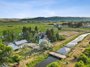 Aerial view of sparsely populated area featuring a water and mountain view