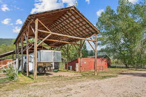View of parking with a carport and dirt driveway