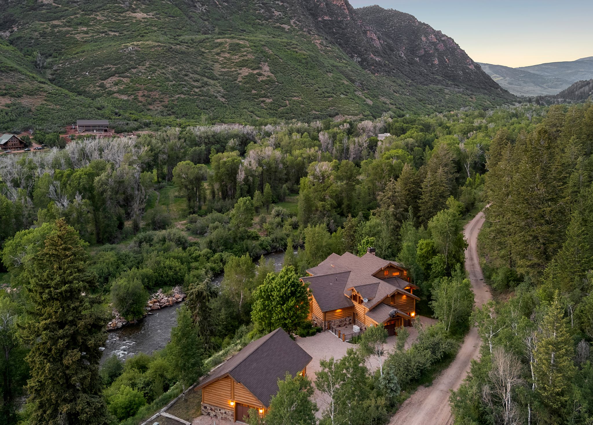 Aerial view at dusk of a view of trees and a mountain view