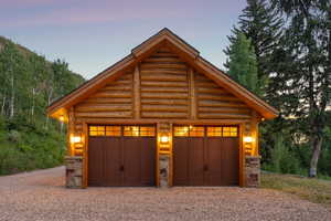 Garage at dusk featuring a detached garage