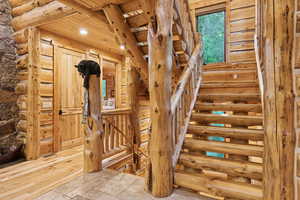 Stairs featuring recessed lighting, stone tile floors, and wooden ceiling