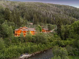 Aerial view of property and surrounding area with a heavily wooded area