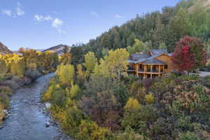 Drone / aerial view of a water and mountain view and a heavily wooded area