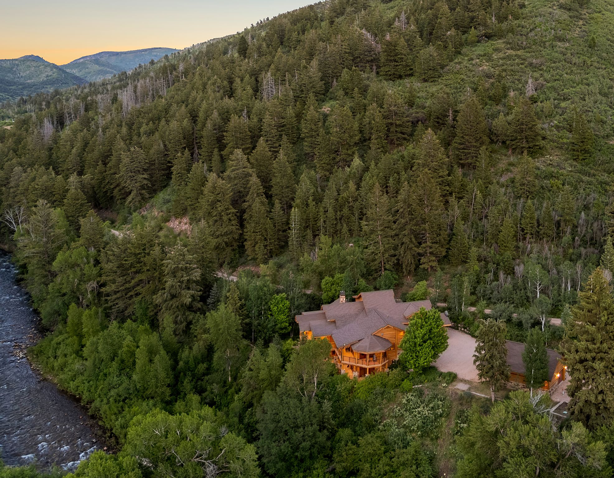 Aerial view at dusk of a view of trees and a mountain view
