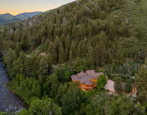 Aerial view at dusk of a view of trees and a mountain view