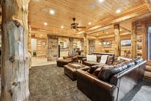Cinema featuring rustic walls, wood ceiling, recessed lighting, carpet, and ceiling fan
