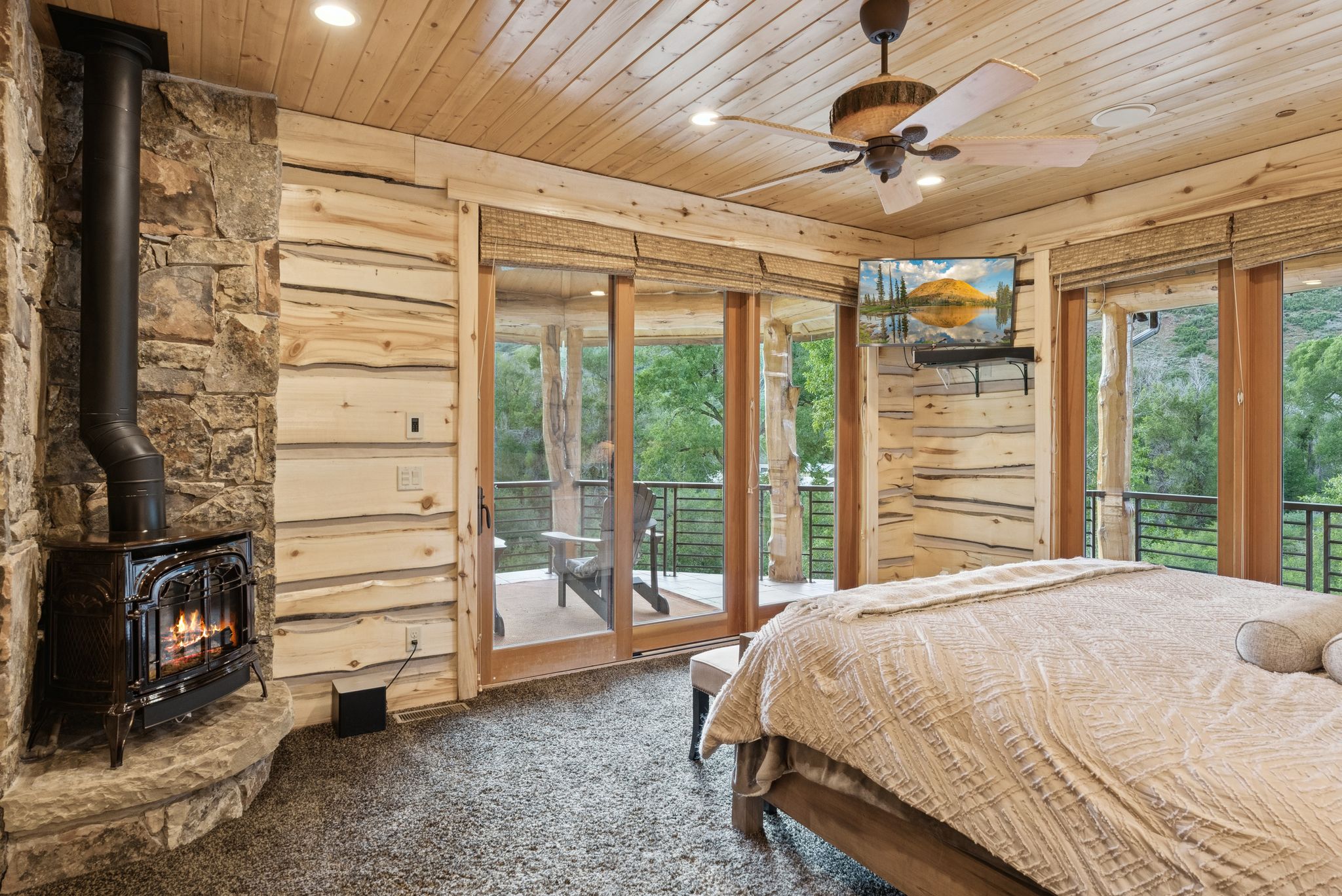 Carpeted bedroom featuring a propane stove, tongue-in-groove ceiling, recessed lighting, and access to exterior