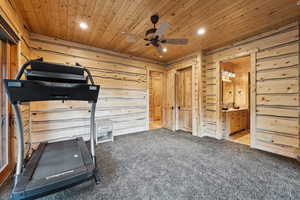 Exercise area with ceiling fan, wooden walls, carpet, recessed lighting, and wooden ceiling