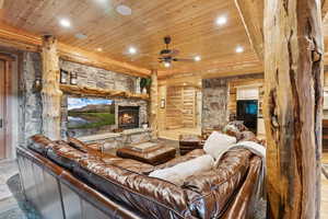 Living area featuring wood ceiling, recessed lighting, a fireplace, and ceiling fan