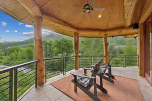 View of patio featuring a mountain view and ceiling fan