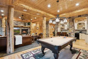 Playroom with a ceiling fan, a fireplace, a wooden ceiling with exposed beams, billiards, and light wood-type flooring