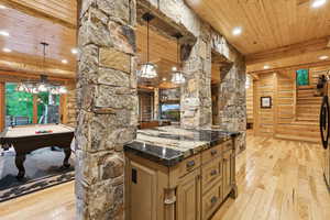 Kitchen with light wood-style floors, a wooden ceiling with exposed beams, recessed lighting, pool table, and decorative light fixtures