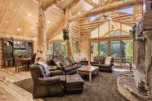 Living area featuring high vaulted ceiling, french doors, a wooden ceiling with exposed beams, recessed lighting, and ceiling fan
