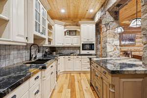 Kitchen featuring wood ceiling, light wood finished floors, open shelves, decorative backsplash, and recessed lighting