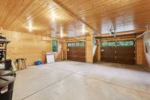 Garage with wooden walls and a garage door opener