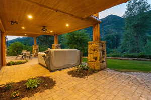 View of patio / terrace with a mountain view, outdoor dining area, and ceiling fan