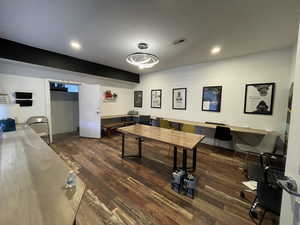 Recreation room with wood finished floors and recessed lighting