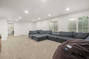 Living room with recessed lighting and light colored carpet