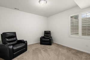 Sitting room featuring carpet and baseboards