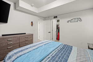 Bedroom featuring a walk in closet and a closet
