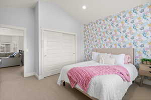 Carpeted bedroom featuring lofted ceiling, a closet, and recessed lighting