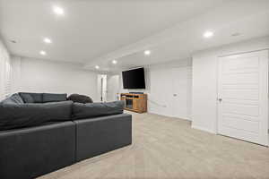 Living area featuring recessed lighting and light colored carpet