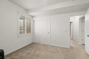 Unfurnished bedroom featuring carpet floors and a closet
