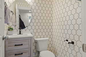 Half bathroom featuring toilet and vanity