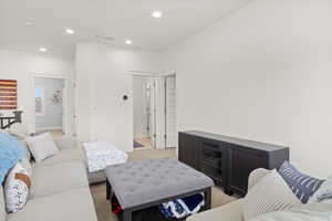 Living room featuring recessed lighting and light colored carpet