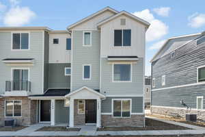 View of property with board and batten siding and stone siding