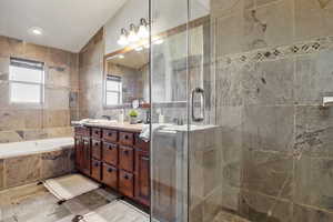 Primary Bathroom featuring dual vanity and glass shower.