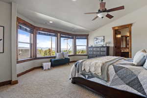 Primary Bedroom featuring carpet flooring, lofted ceiling, recessed lighting, and ensuite bath