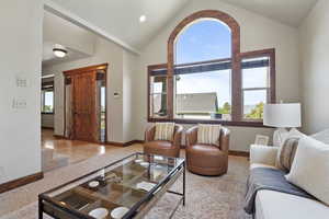 Living area featuring vaulted ceiling
