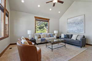 Living room featuring ceiling fan, carpet flooring, recessed lighting, and high vaulted ceiling