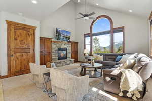 Family Room with recessed lighting, high vaulted ceiling, a fireplace, and a ceiling fan