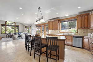 Kitchen with stainless steel appliances, recessed lighting, a kitchen island, healthy amount of natural light, and backsplash
