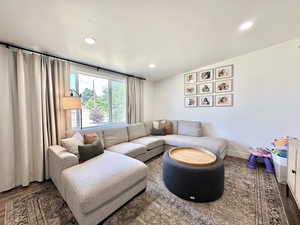 Living area featuring wood finished floors and recessed lighting