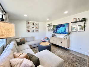 Living room with wood finished floors and recessed lighting