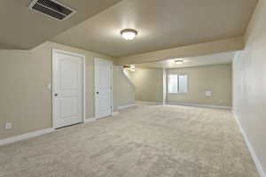Below grade area with light carpet and baseboards
