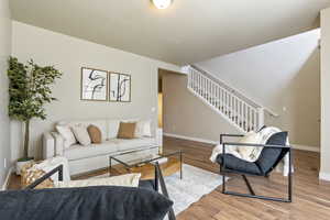 Living room featuring stairs and wood finished floors