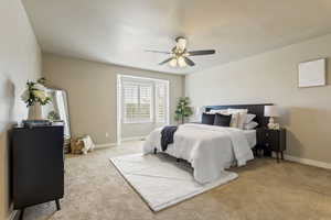 Bedroom featuring light carpet and ceiling fan